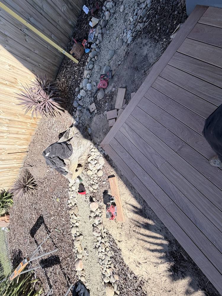 Overhead view of a dark hardwood deck with a picture-frame border running around the edge
