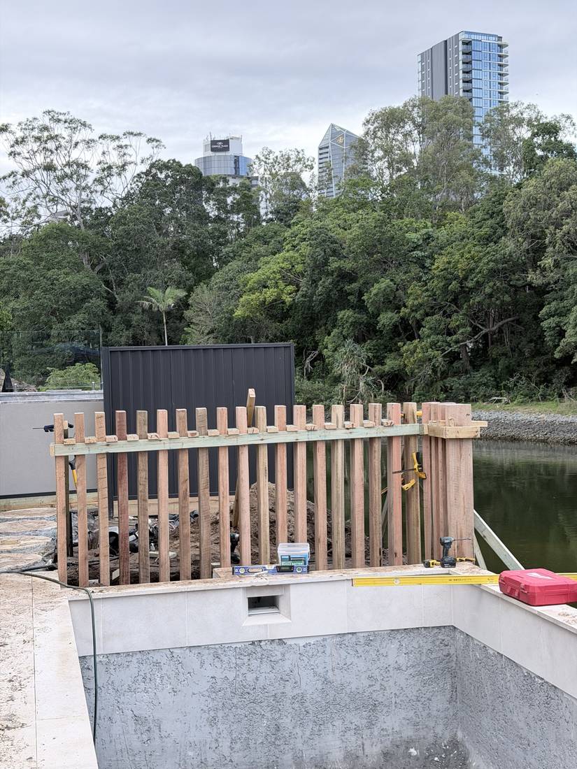 The same hardwood pool screen from the pool side, with city towers behind